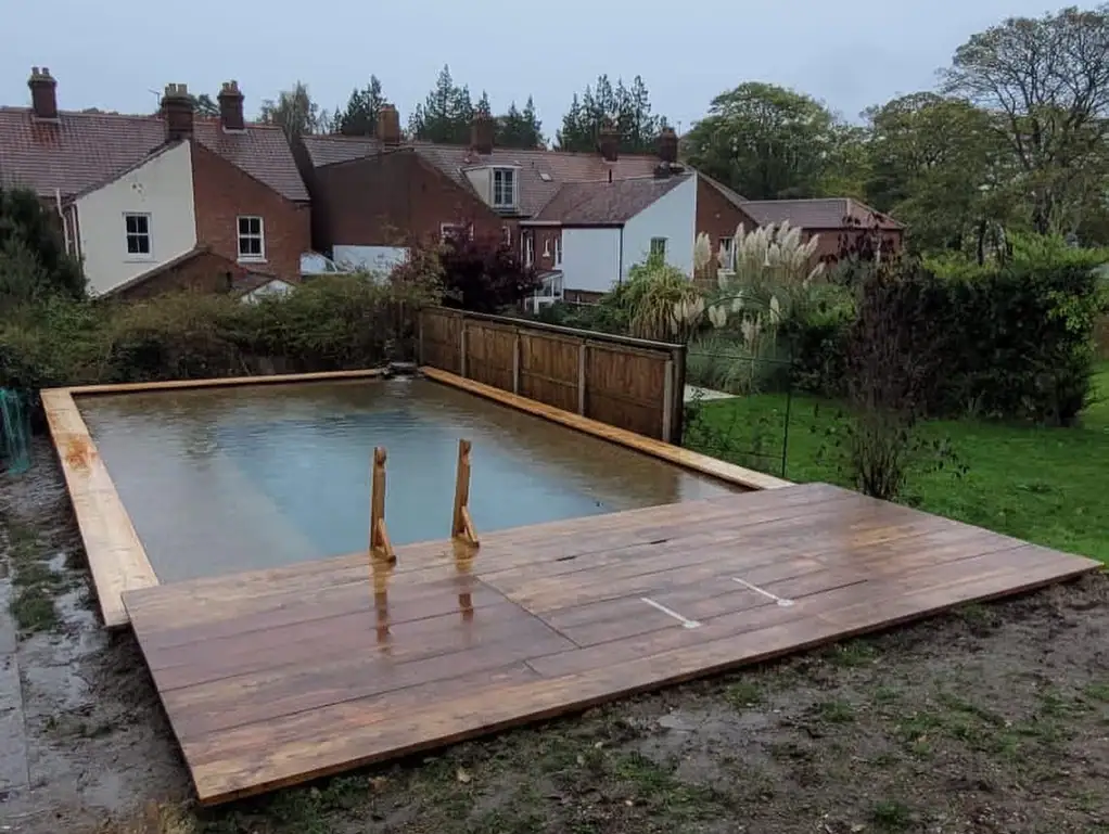 Back garden pool flooded with water and decking