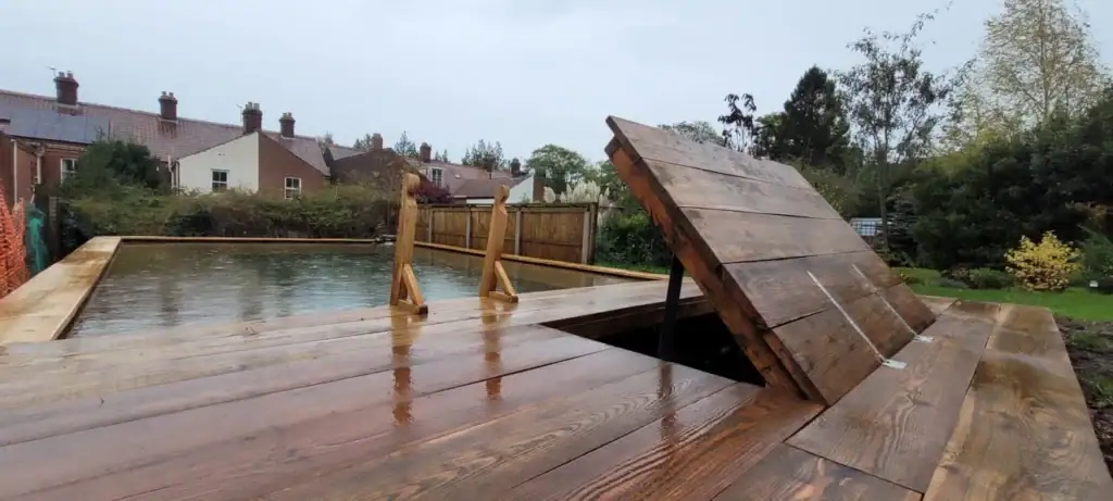Wooden deck with hidden pool hatch open