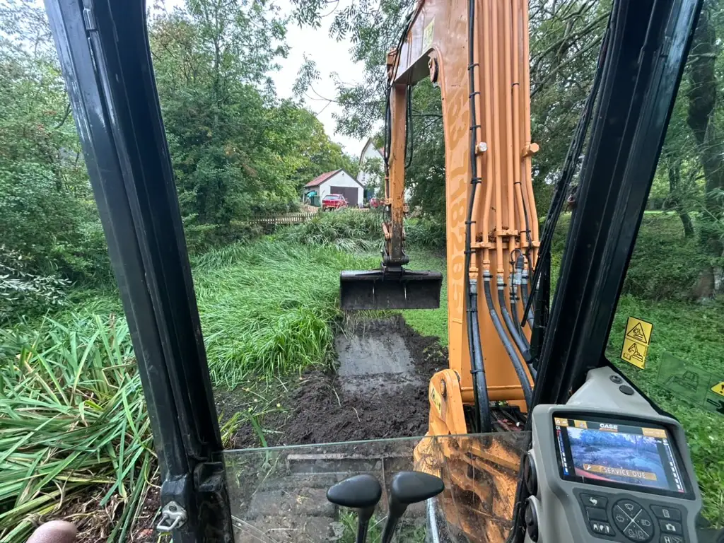 View from excavator digging trench in garden